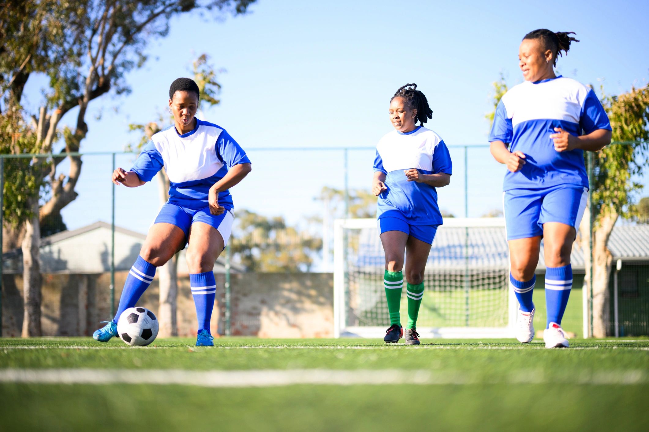 Youth players practicing passing drills on a football pitch