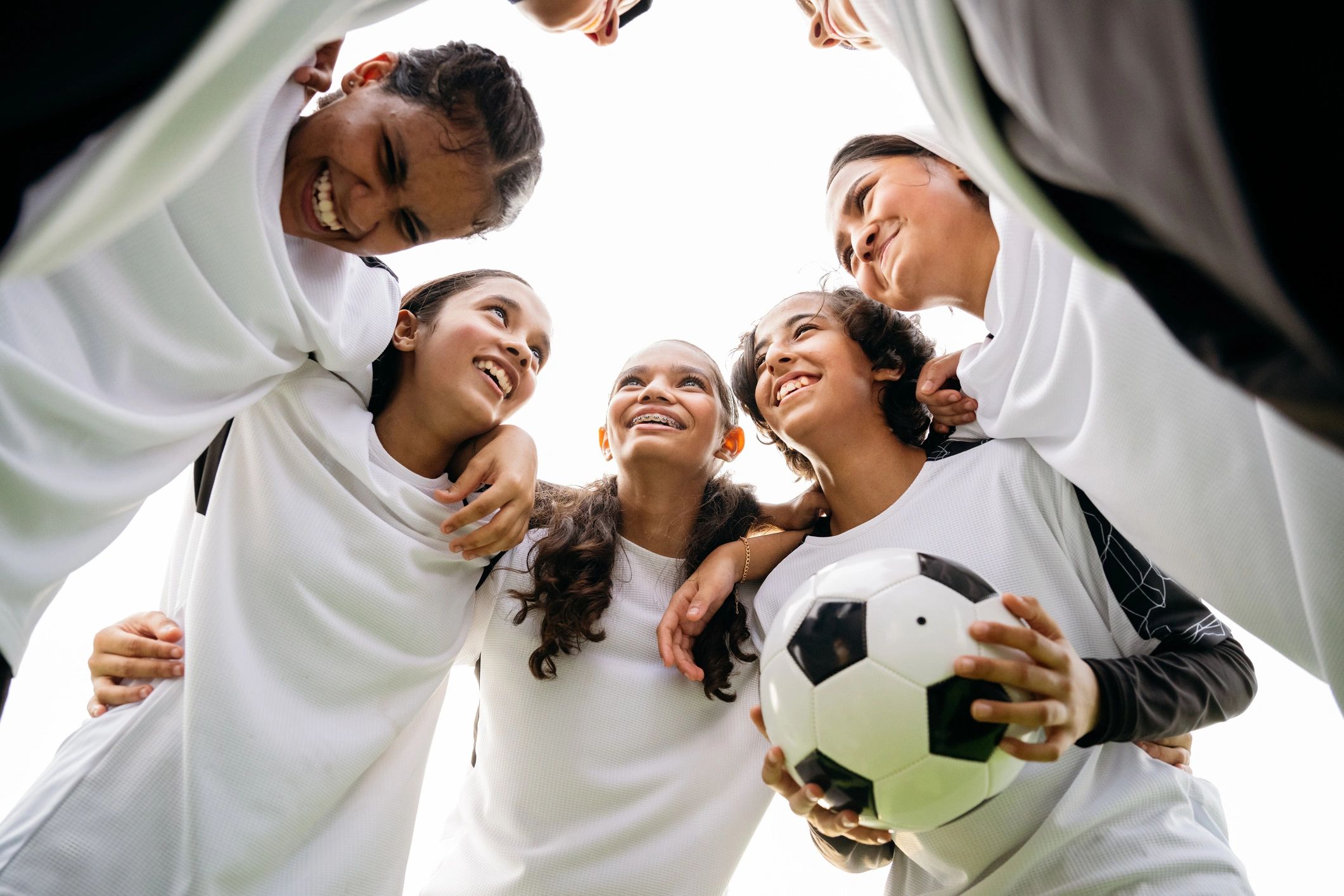 Youth football players in a team huddle
