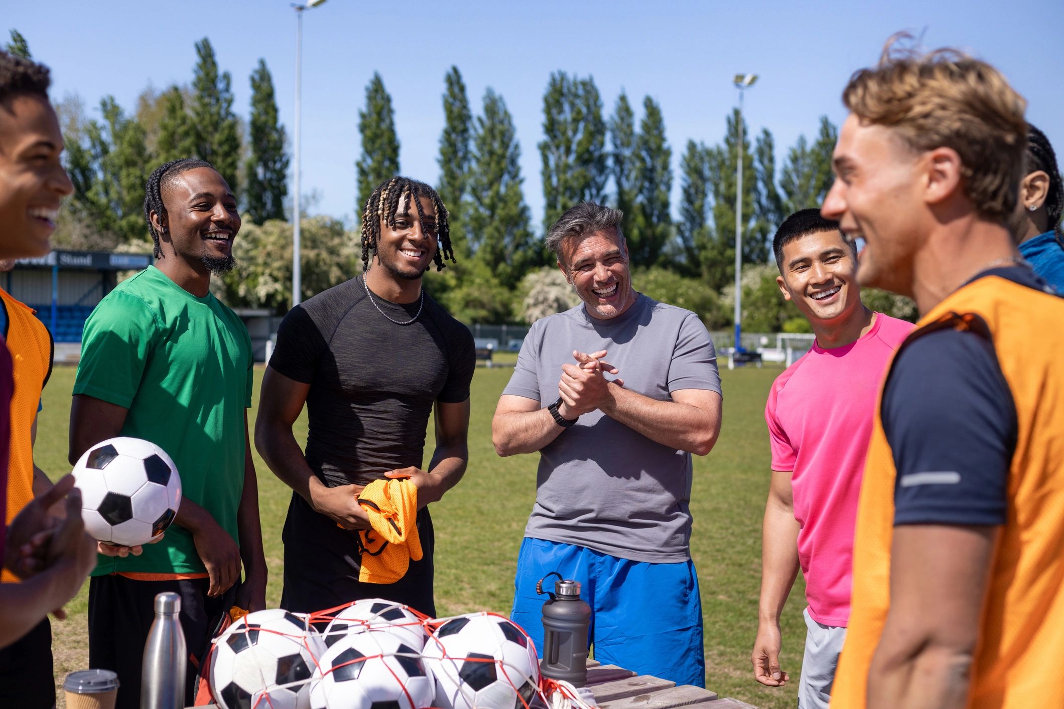 Coach speaking with youth players during football training