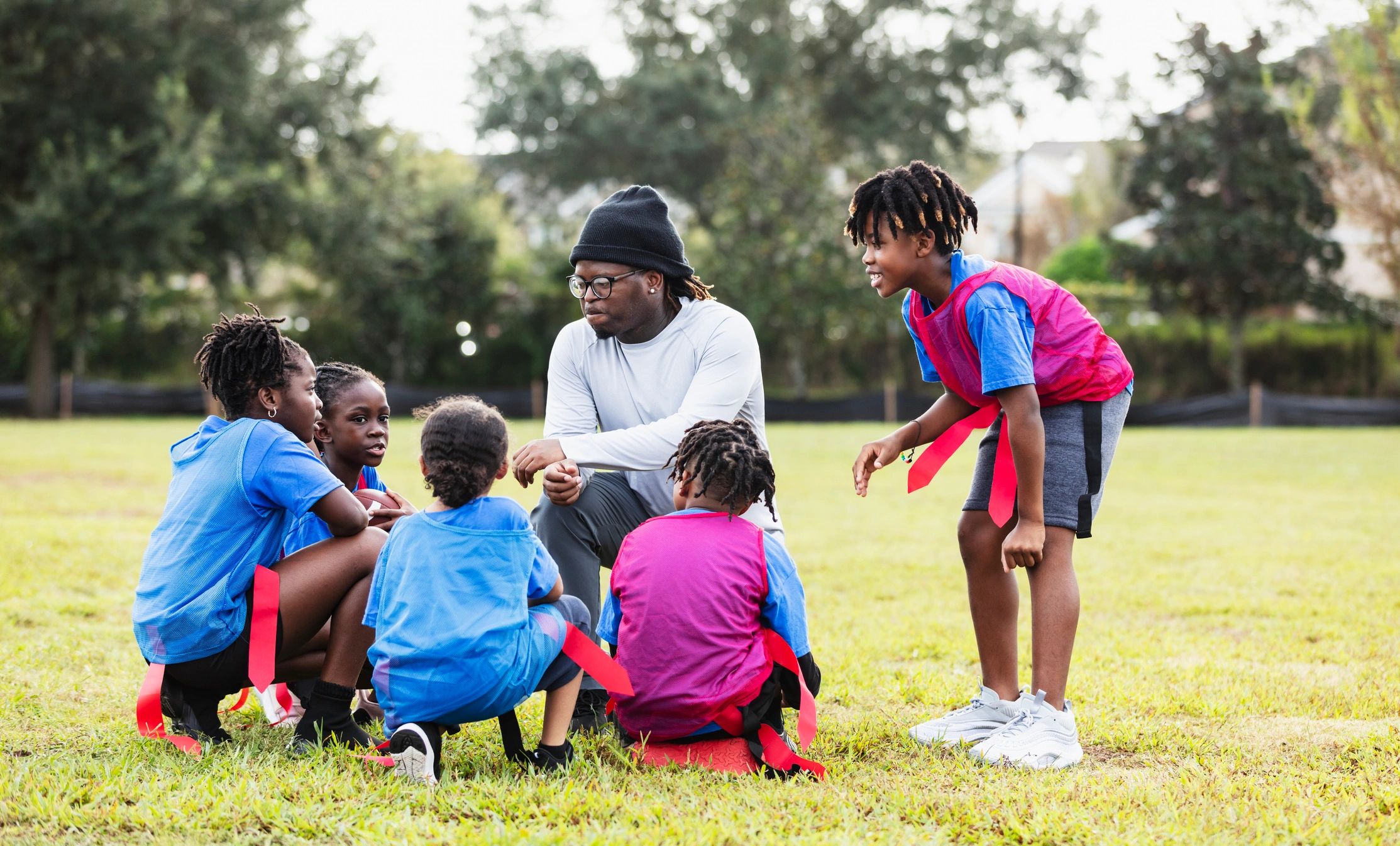 Youth football team huddle before a game